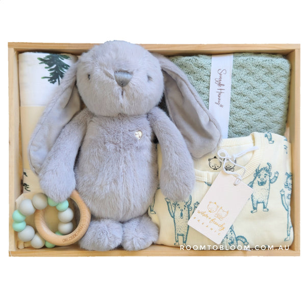 ROOM TO BLOOM Alpha Baby Gift Hamper set with plush bunny, teething ring, blanket and more in a wooden box.