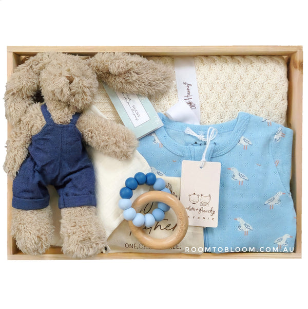 ROOM TO BLOOM Beachside Baby Gift Hamper Baby gift set with bunny, romper, blanket, teething ring and more in a wooden box.