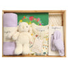 ROOM TO BLOOM Bloom Box Baby Gift Hamper set in a wooden box, featuring a cream plush bunny, a cream floral baby zipsuit, a light purple muslin blanket, a cream blamket, a picture book, and a light purple handband, arranged neatly inside the box.