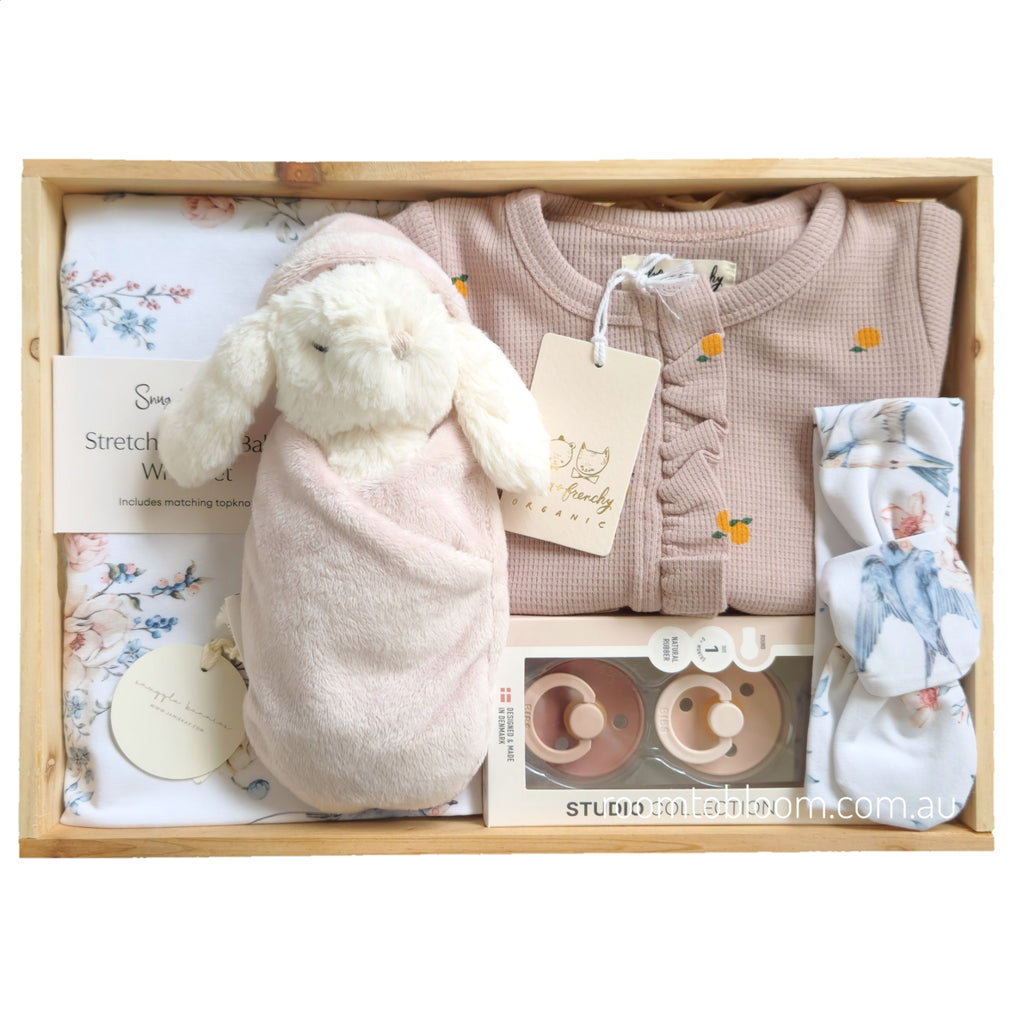 ROOM TO BLOOM Bluebirds Baby Gift Hamper set with clothing, plush toy, and other items in a wooden box.