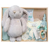 Baby gift set with plush rabbit, baby clothes, teething ring and more in a wooden box.