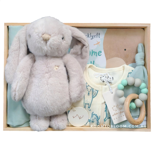 Baby gift set with plush rabbit, baby clothes, teething ring and more in a wooden box.