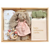 ROOM TO BLOOM Cherished Baby Gift Hamper set arranged in a wooden box, featuring a plush bunny doll in a pink dress, white cotton muslin swaddle, a sage green ribbed bow headband, wooden beaded teether, and a milestone card set.