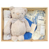 ROOM TO BLOOM Circus Fun Baby Gift Hamper set arranged in a light wood box, featuring a cream plush teddy bear with a striped bow tie, a zipsuit, and Lamington socks and a bib.