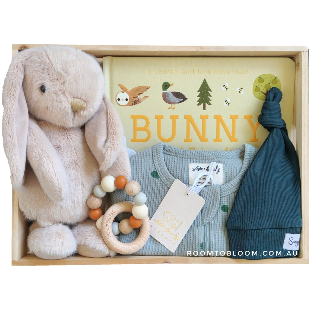 ROOM TO BLOOM Clover Baby Gift Hamper set with plush toy, clothing, and accessories in a box.