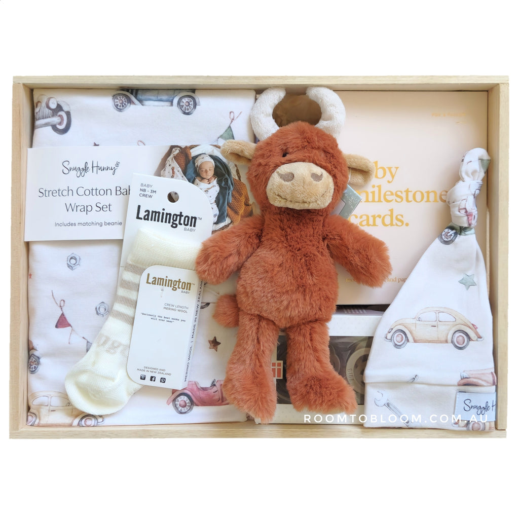 ROOM TO BLOOM Country Roads Baby Gift Hamper set with plush toy, milestone cards, and other items in a wooden box.