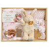 ROOM TO BLOOM Dolly Baby Gift Hamper set in a light wood tray, featuring a cream plush bunny with a brown flower, a pink stretch cotton wrap and beanie, a wooden teething ring, and a pink knit blanket. 