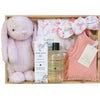 ROOM TO BLOOM Flamboyant Flamingos Baby Gift Hamper set in a wooden box featuring a light pink plush bunny, a swaddle and matching headband, a pink knit playsuit, Bondi Wash Baby Wash, and a baby balm.