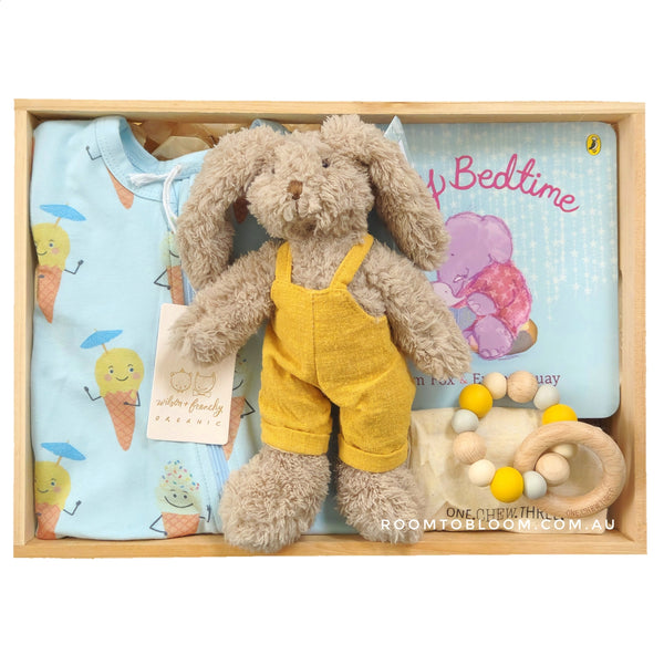 ROOM TO BLOOM Fun Days Baby Gift Hamper set with a bunny in yellow overalls, baby onesie, and book and teether in a wooden box.