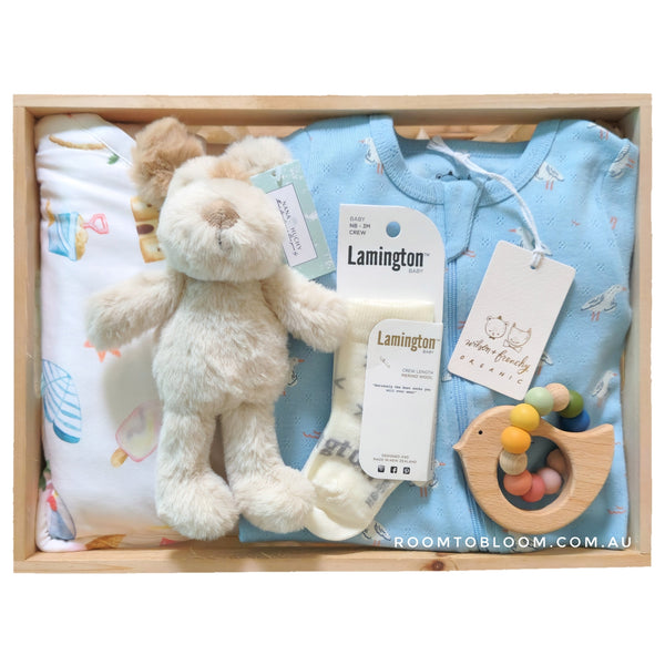 ROOM TO BLOOM Fun in the Sun Baby Gift Hamper set with plush toy, baby clothing, and socks and more in a wooden box.