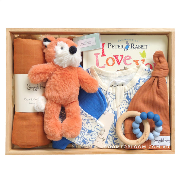 ROOM TO BLOOM Fun with Friends Baby Gift Hamper set with fox plush toy, organic swaddle, teething ring, and more in a wooden box.