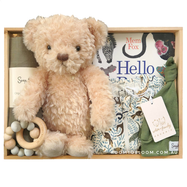 ROOM TO BLOOM Go Wild Baby Gift Hamper with baby items in a box, including a teddy bear, clothing, a swaddle and more. 