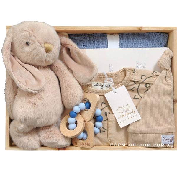 ROOM TO BLOOM Happy Days Baby Gift Hamper set with plush bunny, baby clothes, a teething ring and more in a wooden box.