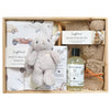 ROOM TO BLOOM  Joyful Journeys Baby Gift Hampert set with items including a plush toy, wrap, and bath products in a wooden box.