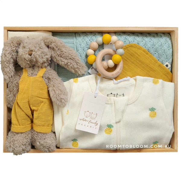ROOM TO BLOOM Little Pineapple Baby Gift Hamper set with plush toy, clothing, teething ring and more in a wooden box.
