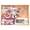 ROOM TO BLOOM Matilda Baby Gift Hamper set arranged in a light wood tray, featuring a grey koala plush toy, a purple and pink swaddle, a teething ring, a book titled 'This Little Joey' by Renée Treml, and two bandana bibs.