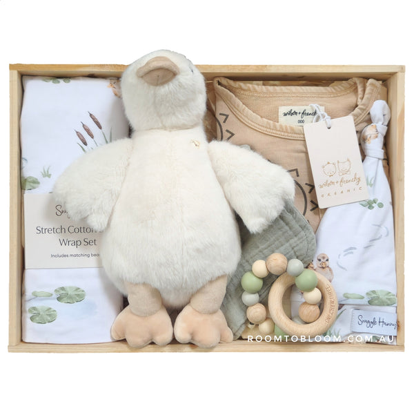 ROOM TO BLOOM Mother Duck Baby Gift Hamper set with plush toy, baby clothes, a toy and more in a wooden box.