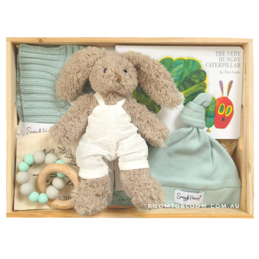 ROOM TO BLOOM Nature Trail Baby Gift Hamper set with blanket, plush toy, teether, and more in a wooden box.