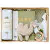 ROOM TO BLOOM Oasis Baby Gift Hamper set with plush camel, baby blanket, and other items in a wooden box.