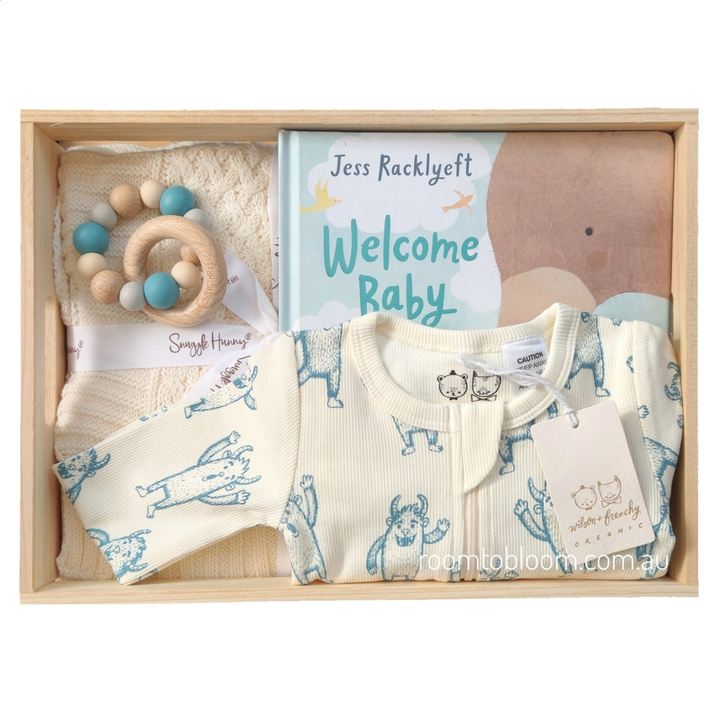 ROOM TO BLOOM Peek-a-Boo Baby Gift Hamper set in a light wood box featuring a cream zip-up baby romper, a wooden beaded teether, a book and blanket.