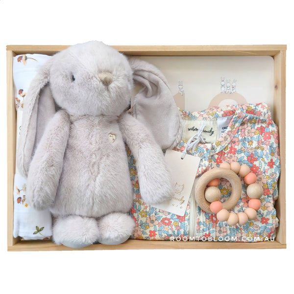 ROOM TO BLOOM Petit Petals Baby Gift Hamper set with plush bunny, teething ring, floral romper and more in a wooden box.