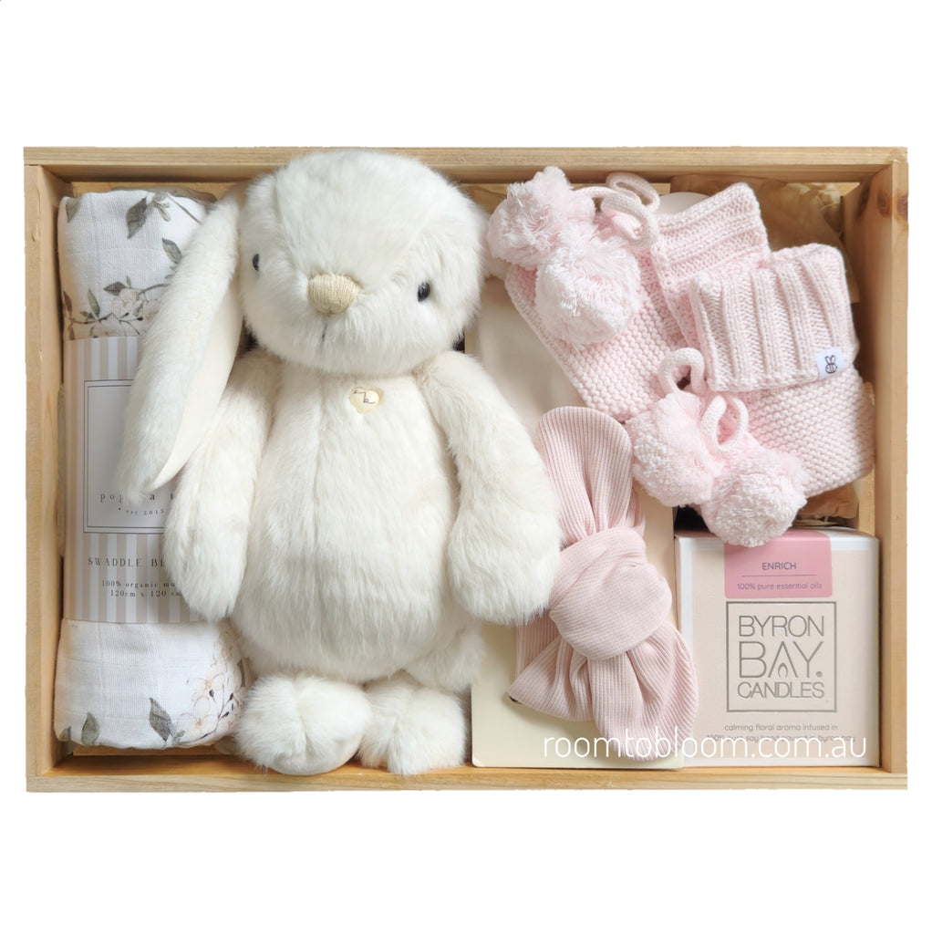 ROOM TO BLOOM Powder Pink Baby Gift Hamper set with plush bunny, swaddle, a candle and more in a wooden box.