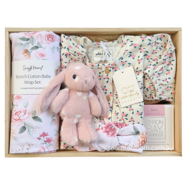 ROOM TO BLOOM Pretty Petal Baby Gift Hamper set in a light wood box featuring a pink plush bunny, a floral baby wrap set, a floral baby dress, and a Byron Bay candle.