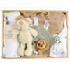 ROOM TO BLOOM Puppy Park Baby Gift Hamper set in a wooden box featuring a cream plush dog toy, a white printed wrap with a beanie, a beige knit blanket, a sage green muslin bib, and a wooden bead teether.