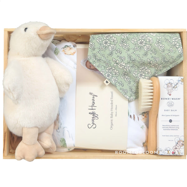 ROOM TO BLOOM Quacking Good Time Baby Gift Hamper gift set with plush duck, towel, and other items in a wooden box.