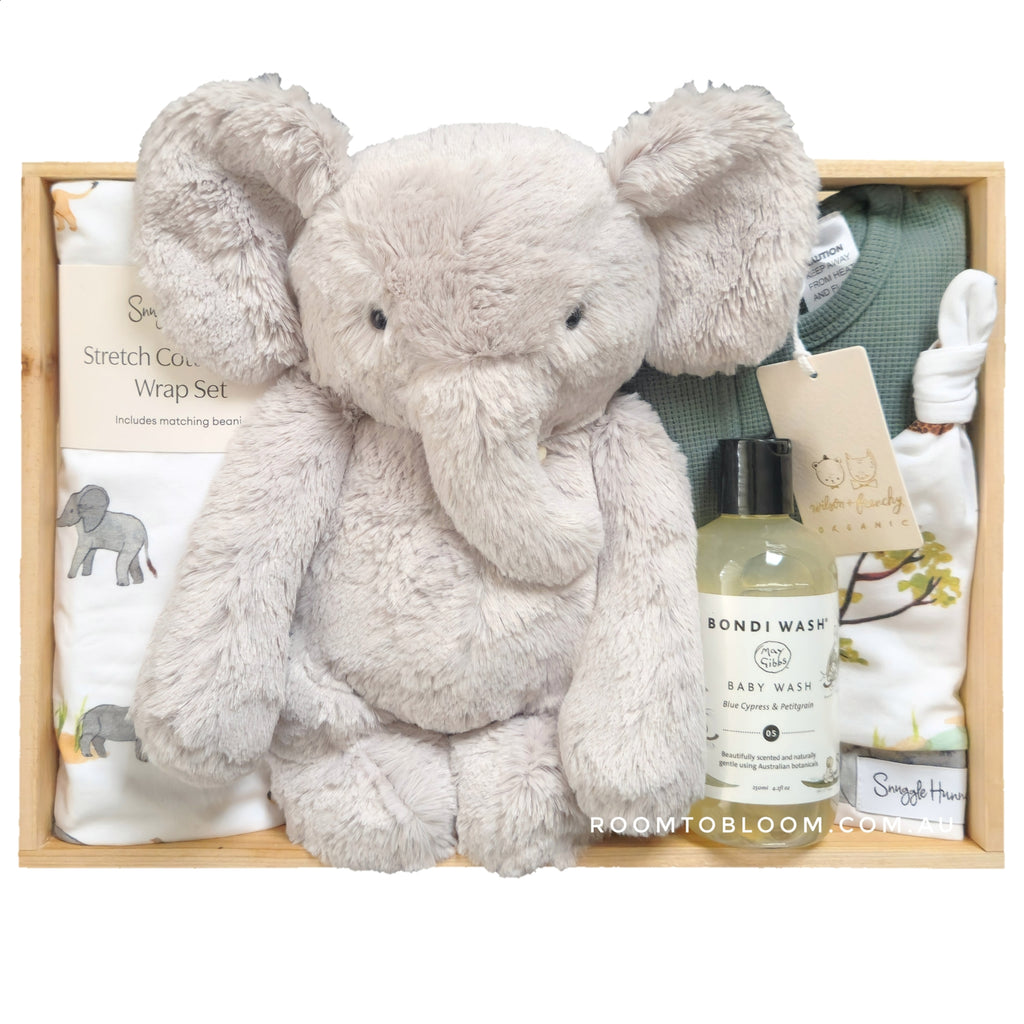 ROOM TO BLOOM Safari Adventure Baby Gift Hamper gift set with plush elephant toy, baby wash, and other items in a wooden box.