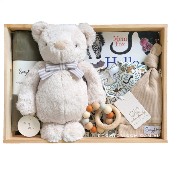 ROOM TO BLOOM Safari Adventure Baby Gift Hamper set with plush toy, swaddle, and other items in a wooden box.
