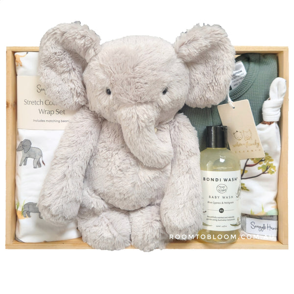 ROOM TO BLOOM Safari Adventure Baby Gift Hamper gift set with plush elephant toy, baby wash, and other items in a wooden box.