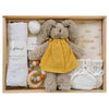 ROOM TO BLOOM Shine Bright Baby Gift Hamper set arranged in a light wood box, featuring a plush bunny in a yellow dress, white knitted booties, a cotton muslin swaddle wrap, a wooden teething ring, and more.