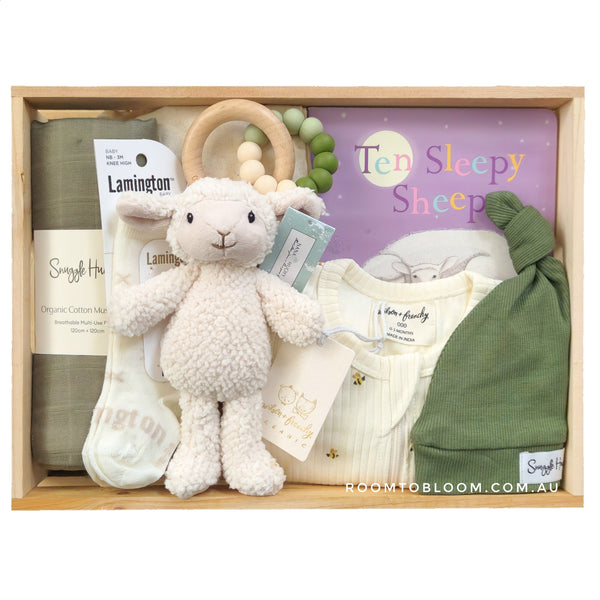 ROOM TO BLOOM Sleepy Time Baby Gift Hamper set with plush lamb, hat, and other items in a wooden box.