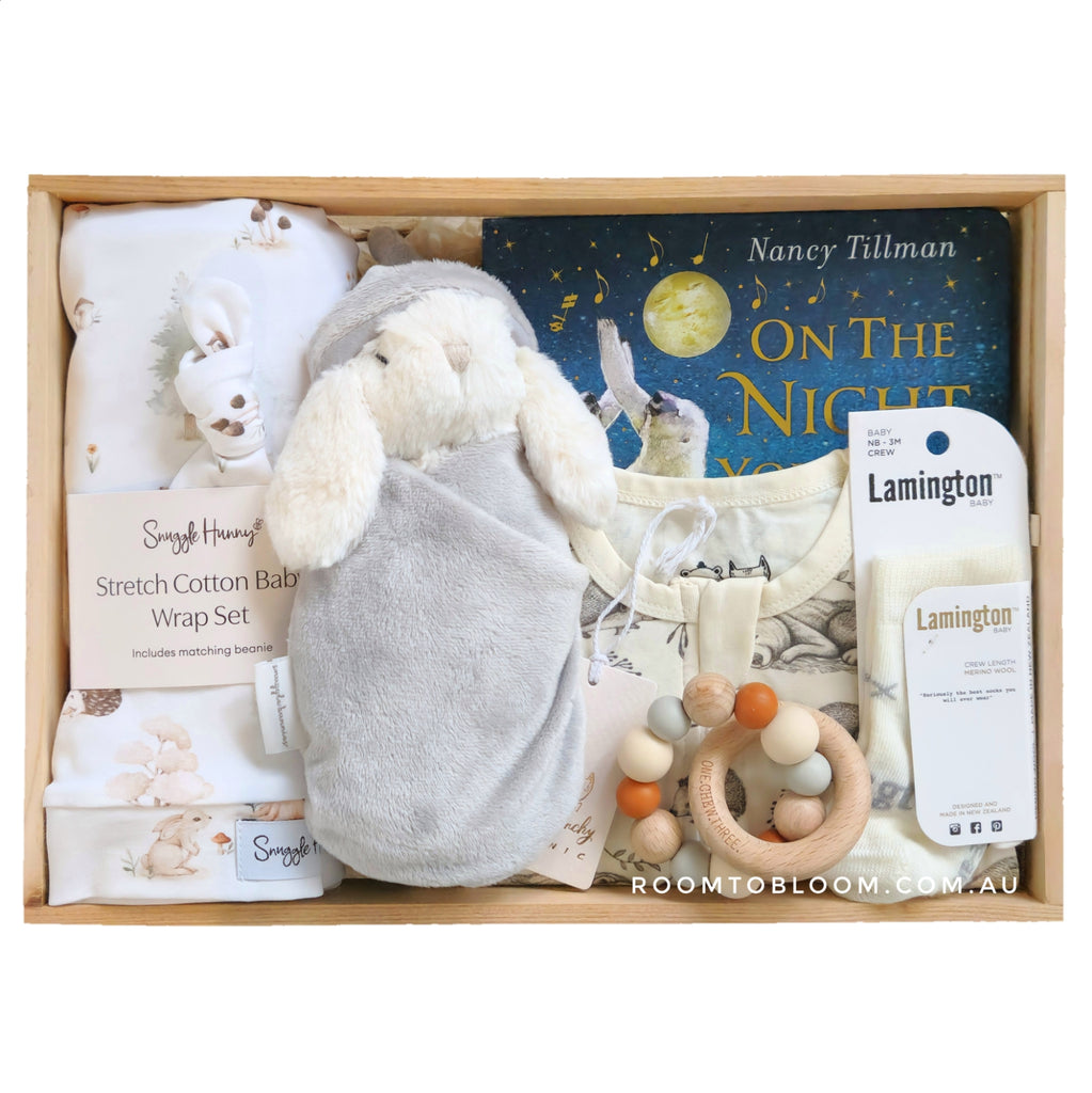ROOM TO BLOOM Starry Starry Night Baby Gift Hamper set with swaddle, plush bunny, rattle, Nancy Tillman's 'On the Night You Were Born' book, and more in a wooden box.