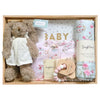 ROOM TO BLOOM Tea Party Baby Gift Hamper set with a toy bunny, swaddle, and other items in a wooden box.