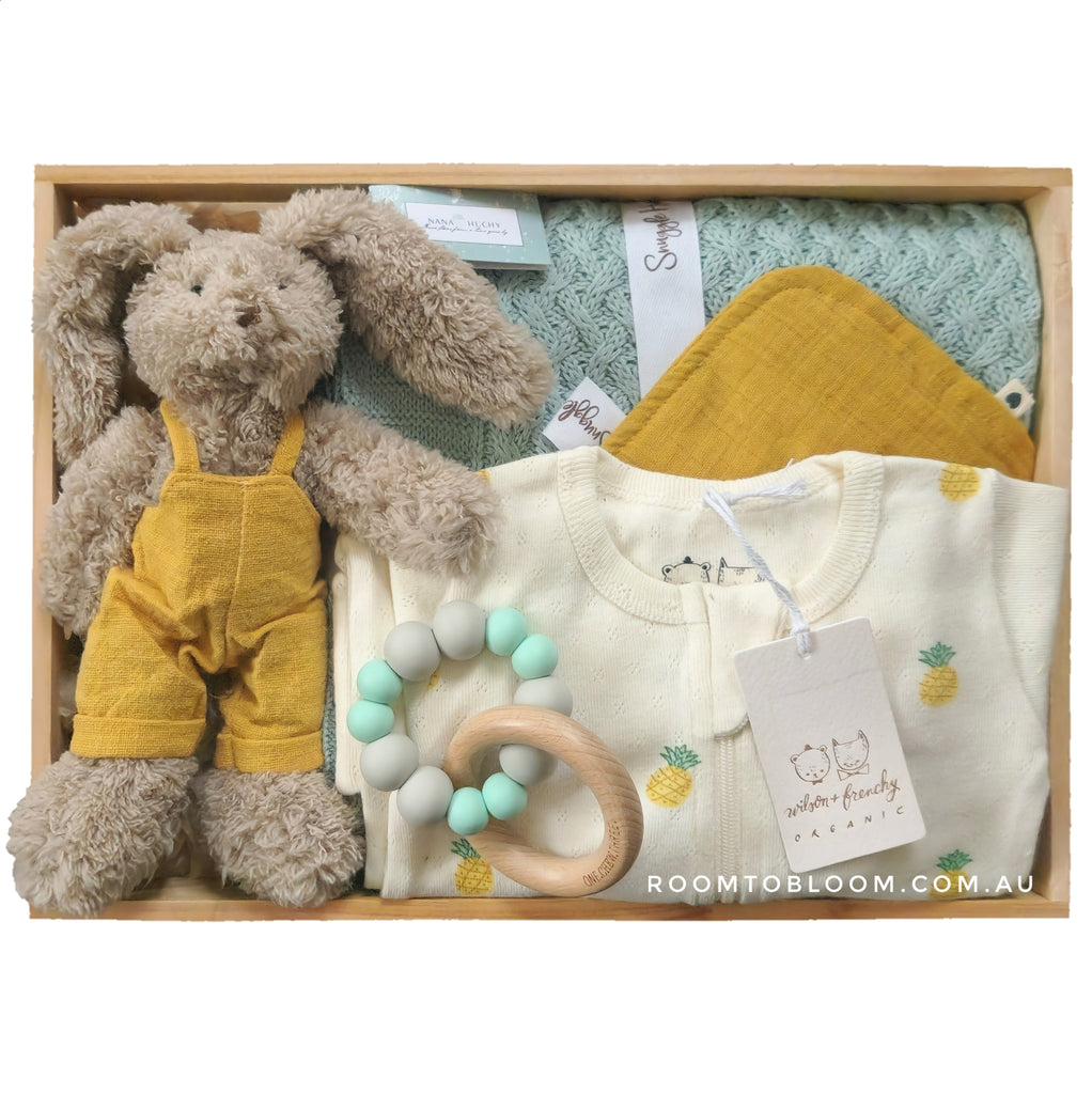 ROOM TO BLLOM Tiny Piney Baby Gift Hamper set with plush toy, baby clothes, teething ring and more in a wooden box.