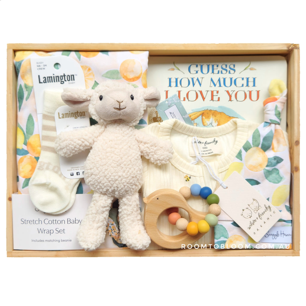 ROOM TO BLOOM Two Fruits Baby Gift Hamper set with plush lamb, baby wrap, toys and more in a wooden box.