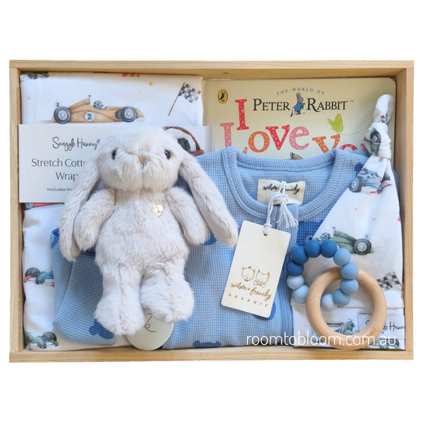 ROOM TO BLOOM Vroom Vroom Baby Gift Hamper set with plush toy, baby clothing, teething ring and more in a wooden box.