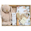 ROOM TO BLOOM Wild Horses Baby Gift Hamper set arranged in a wooden box, featuring a plush bunny toy, Bondi Wash baby balm, a beige blanket, a small wooden-handled brush, and printed swaddle and beane, and mittens.