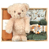 ROOM TO BLOOM Wild World Baby Gift Hamper set with teddy bear, clothing, a toy and more in a wooden box.