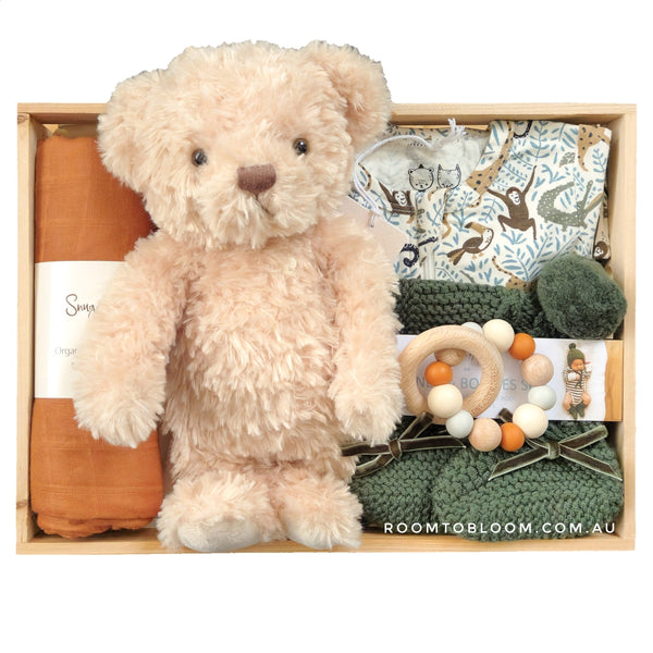 ROOM TO BLOOM Wild World Baby Gift Hamper set with teddy bear, clothing, a toy and more in a wooden box.