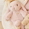 Person holding a SNUGGLE BUNNIES Little Penelope - Blossom toy with a soft background