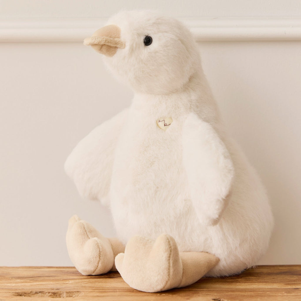 White plush duck SNUGGLE BUNNIES Rose the Duck toy on a wooden surface with a light background
