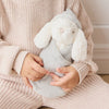 Child holding a SNUGGLE BUNNIES Sleeping Penelope - Willow toy in a cozy setting