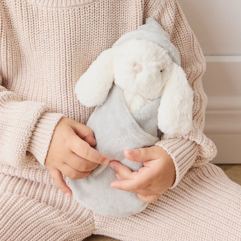 Child holding a SNUGGLE BUNNIES Sleeping Penelope - Willow toy in a cozy setting