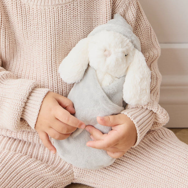 Child holding a SNUGGLE BUNNIES Sleeping Penelope - Willow toy in a cozy setting